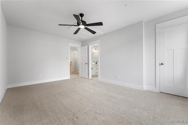unfurnished bedroom with light colored carpet, baseboards, and ensuite bathroom