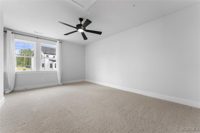 unfurnished room with carpet flooring, baseboards, and a ceiling fan