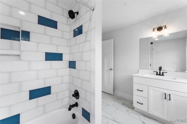 bathroom with marble look tiles, vanity, tub / shower combination, and baseboards