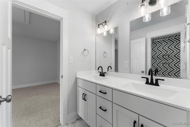 bathroom with baseboards and double vanity