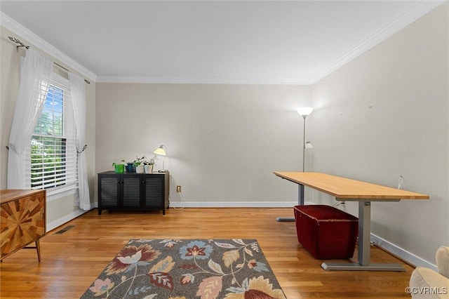 office area with crown molding, wood finished floors, and baseboards