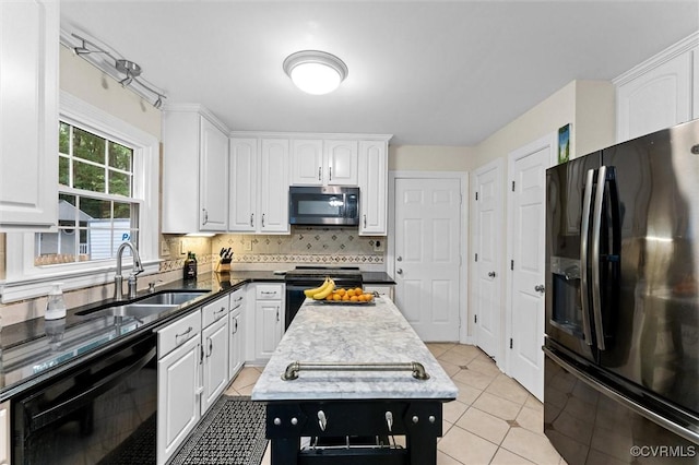 kitchen featuring black fridge with ice dispenser, stainless steel microwave, a sink, and white cabinetry
