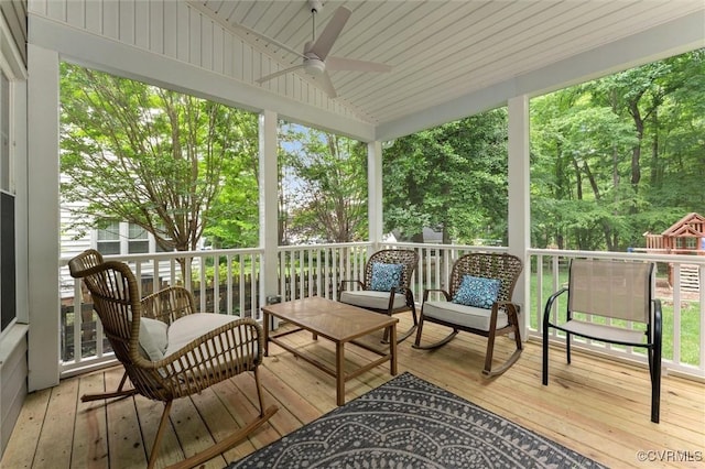 sunroom / solarium featuring ceiling fan, an outdoor living space, and vaulted ceiling