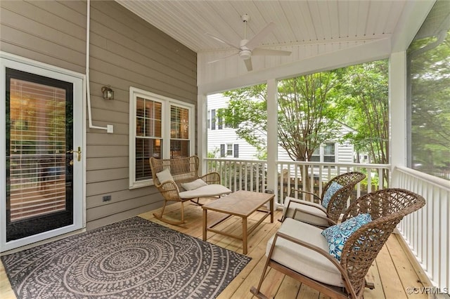 sunroom featuring ceiling fan