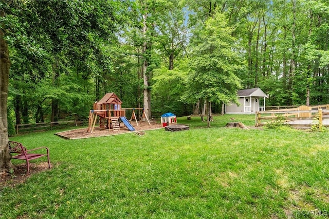 view of yard featuring a playground and an outbuilding