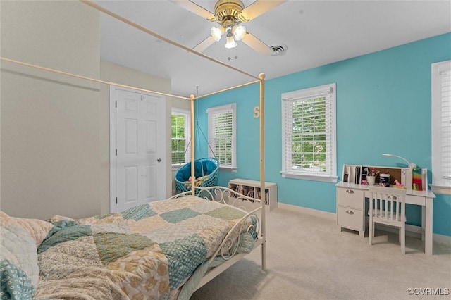 carpeted bedroom featuring baseboards and a ceiling fan