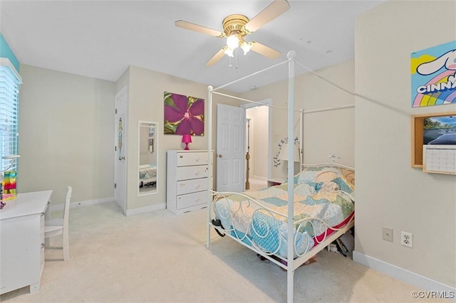 carpeted bedroom with baseboards and ceiling fan