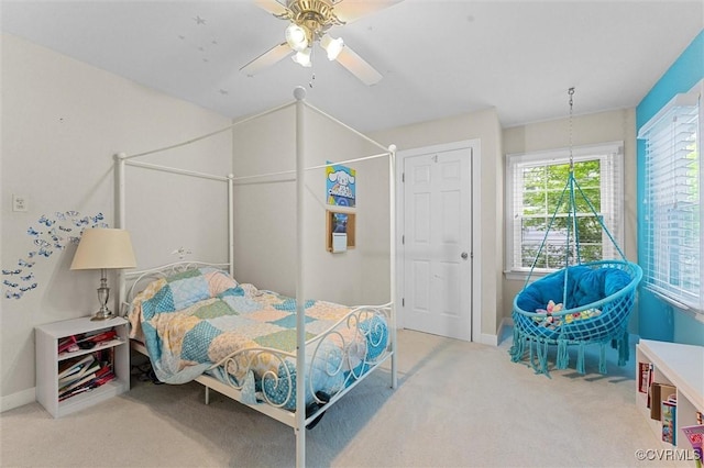 carpeted bedroom with baseboards and a ceiling fan