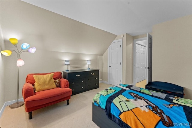carpeted bedroom with vaulted ceiling and baseboards
