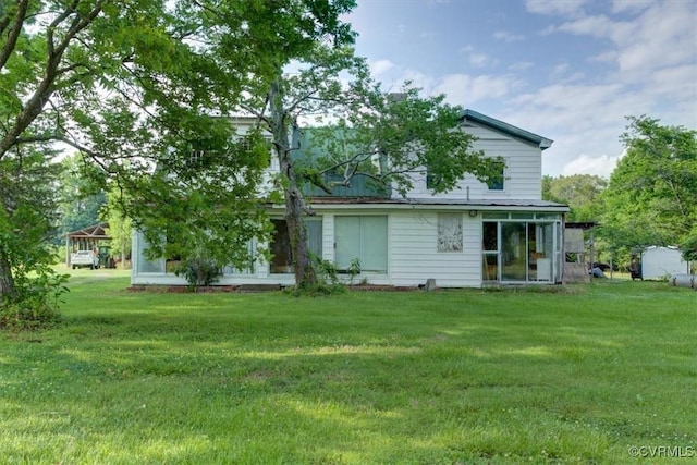 9615 E Quaker Rd, Disputanta, VA 23842 - rear view of house featuring a sunroom and a lawn