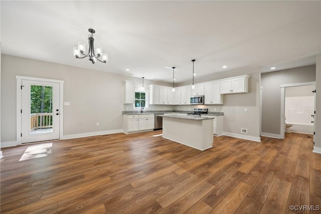 10940 Cross County Rd, Mineral, VA 23117 - kitchen with stainless steel appliances, a chandelier, dark wood-style floors, white cabinetry, and recessed lighting