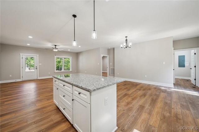 10940 Cross County Rd, Mineral, VA 23117 - kitchen with open floor plan, a chandelier, hardwood / wood-style floors, white cabinetry, and a ceiling fan