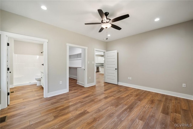 10940 Cross County Rd, Mineral, VA 23117 - unfurnished bedroom with a spacious closet, light wood-type flooring, baseboards, a closet, and ensuite bathroom