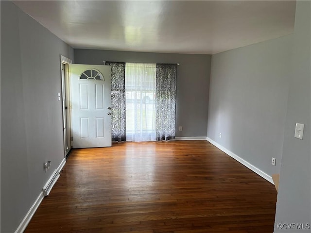 foyer entrance featuring dark wood-type flooring and baseboards