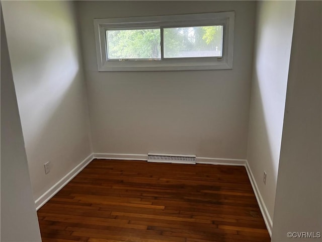 unfurnished room featuring hardwood / wood-style flooring and baseboards