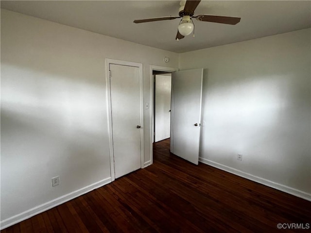 unfurnished bedroom with baseboards, wood finished floors, and a ceiling fan