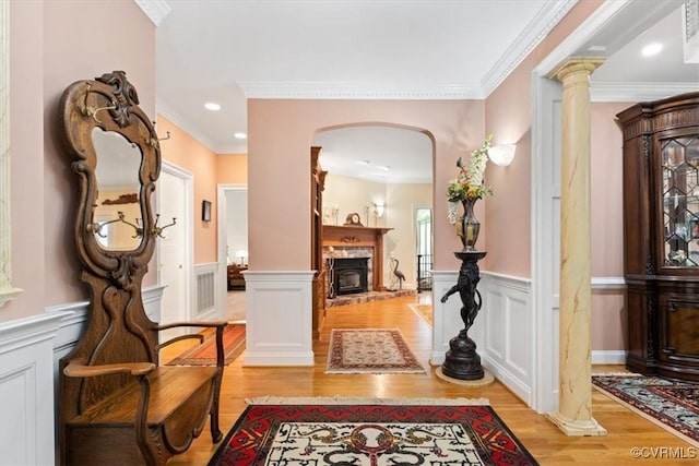 11216 Woodstock Heights Dr, Glen Allen, VA 23059 - hall with light wood-style flooring, wainscoting, ornamental molding, arched walkways, and a decorative wall