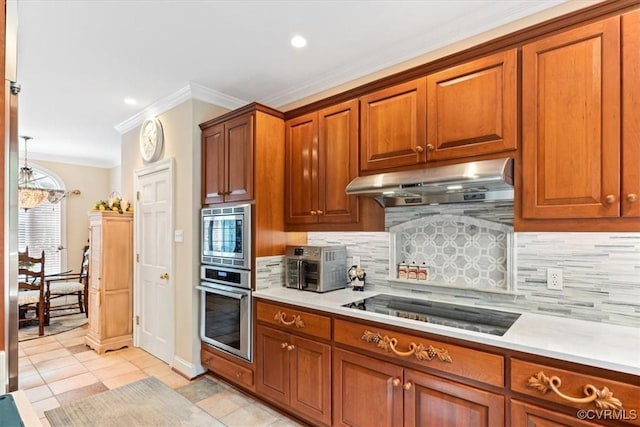 11216 Woodstock Heights Dr, Glen Allen, VA 23059 - kitchen featuring appliances with stainless steel finishes, under cabinet range hood, light countertops, ornamental molding, and brown cabinetry