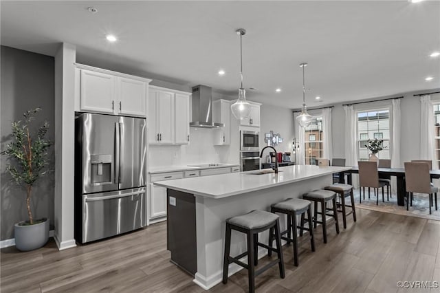 13285 Coalfield Station Ln, Midlothian, VA 23114 - kitchen featuring appliances with stainless steel finishes, wall chimney exhaust hood, an island with sink, a sink, and dark wood-style floors