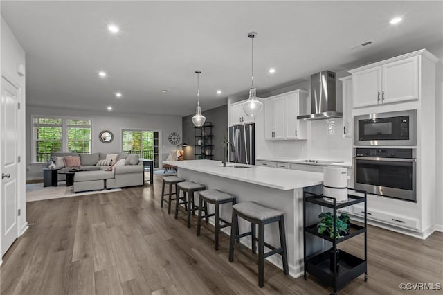 13285 Coalfield Station Ln, Midlothian, VA 23114 - kitchen with stainless steel appliances, wall chimney exhaust hood, light countertops, white cabinets, and recessed lighting