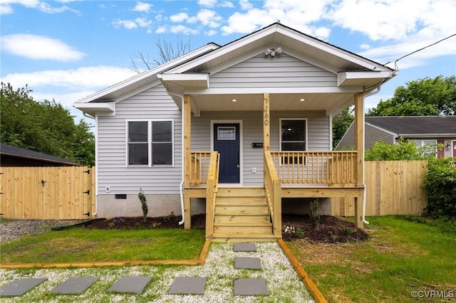view of front of home with covered porch and fence