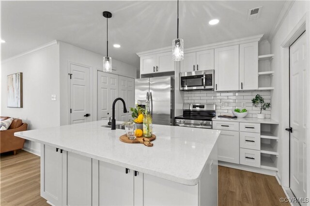 kitchen with stainless steel appliances, open shelves, ornamental molding, white cabinets, and a sink