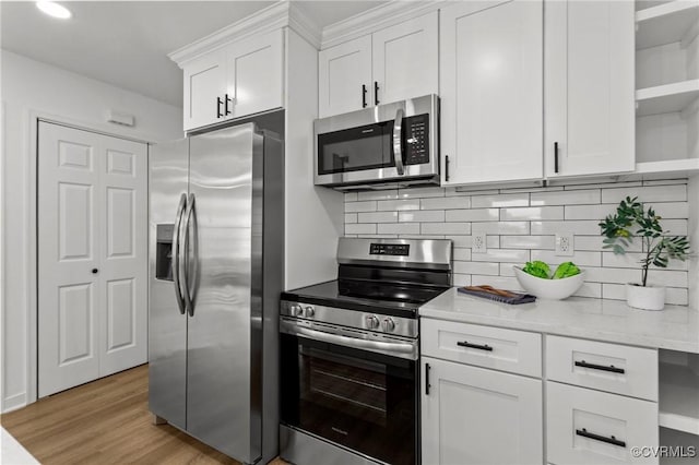 kitchen featuring stainless steel appliances, open shelves, white cabinetry, backsplash, and light wood-type flooring