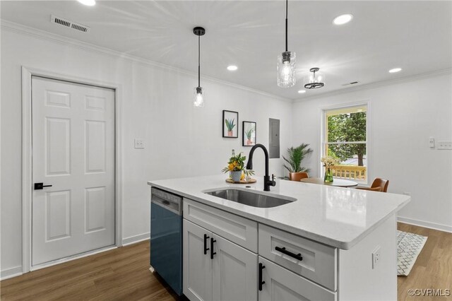 kitchen featuring a sink, dishwashing machine, light countertops, dark wood-style floors, and ornamental molding