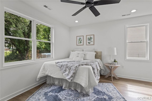 bedroom with baseboards, wood finished floors, recessed lighting, and ceiling fan