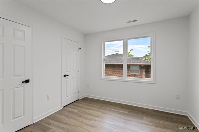 unfurnished bedroom featuring light wood-style flooring and baseboards