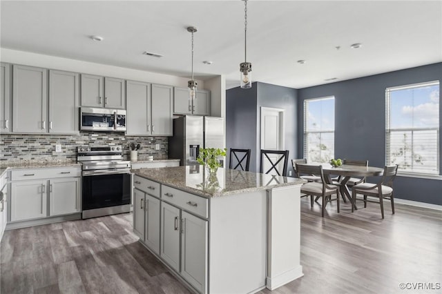 7201 Hancock Chase Ct Unit J2, Chesterfield, VA 23832 - kitchen featuring appliances with stainless steel finishes, gray cabinets, wood finished floors, and decorative backsplash