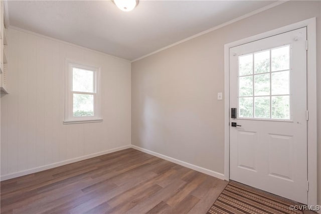 entryway featuring wood finished floors, healthy amount of natural light, baseboards, and ornamental molding