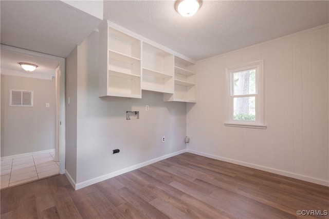 laundry area featuring wood finished floors, baseboards, and hookup for a washing machine
