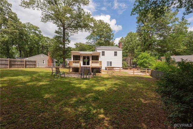 rear view of property with a sunroom, a chimney, and a deck