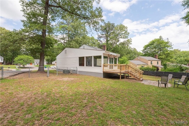 rear view of house featuring central air condition unit, a wooden deck, stairway, and view of wooded area