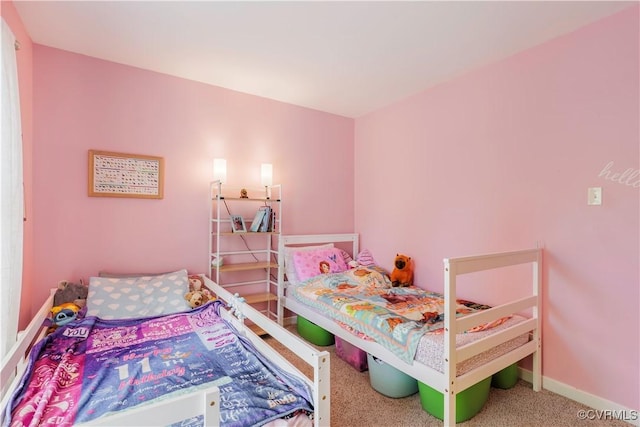 carpeted bedroom featuring baseboards