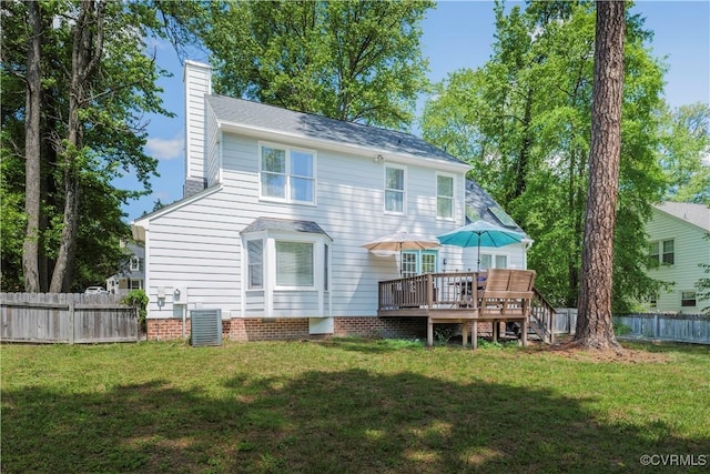 rear view of house with a chimney and a deck