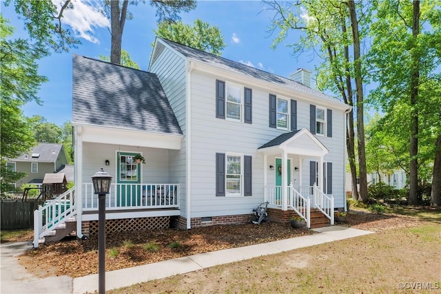 colonial home featuring covered porch, a chimney, a shingled roof, and crawl space