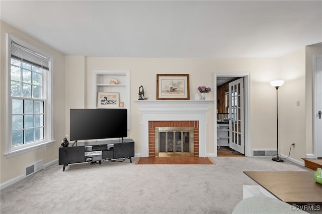 living room featuring carpet flooring, a brick fireplace, and baseboards