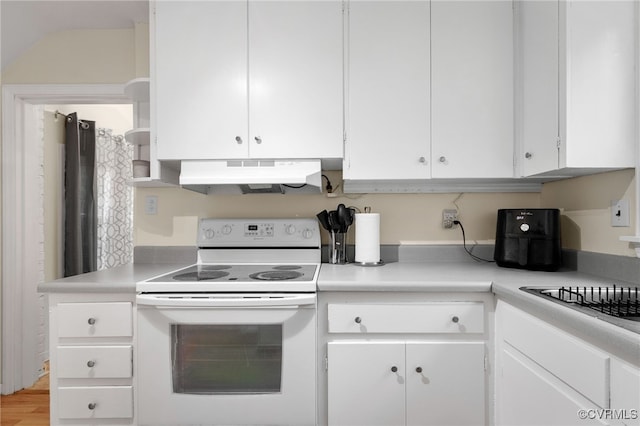 kitchen featuring electric range, under cabinet range hood, white cabinetry, light countertops, and light wood-type flooring