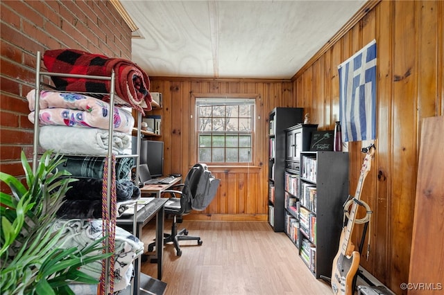 office space featuring wooden walls and light wood finished floors