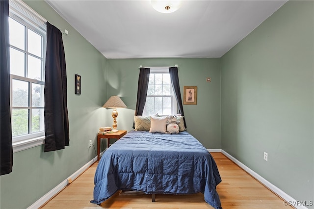 bedroom featuring wood finished floors and baseboards