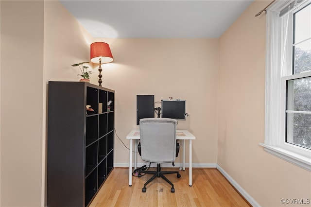 office space featuring light wood-style floors and baseboards