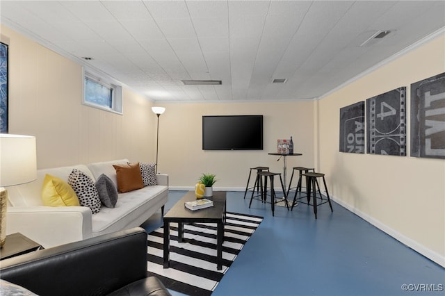 living area featuring finished concrete floors and ornamental molding