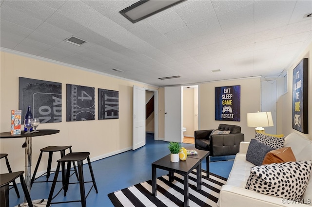 living room with concrete flooring and baseboards