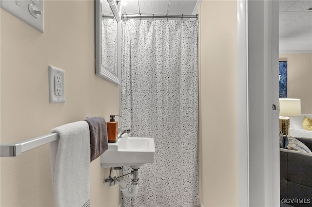 full bath featuring curtained shower and a sink