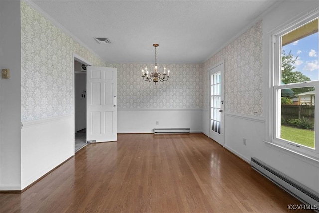 3304 N Marion Ave, Hopewell, VA 23860 - unfurnished dining area with a baseboard heating unit, wallpapered walls, a chandelier, wood finished floors, and wainscoting