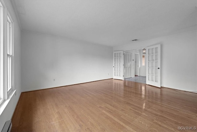 3304 N Marion Ave, Hopewell, VA 23860 - spare room with wood finished floors, a baseboard radiator, and french doors