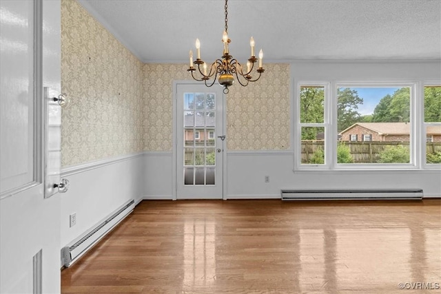 3304 N Marion Ave, Hopewell, VA 23860 - unfurnished dining area featuring a baseboard radiator, a chandelier, wood finished floors, plenty of natural light, and wallpapered walls