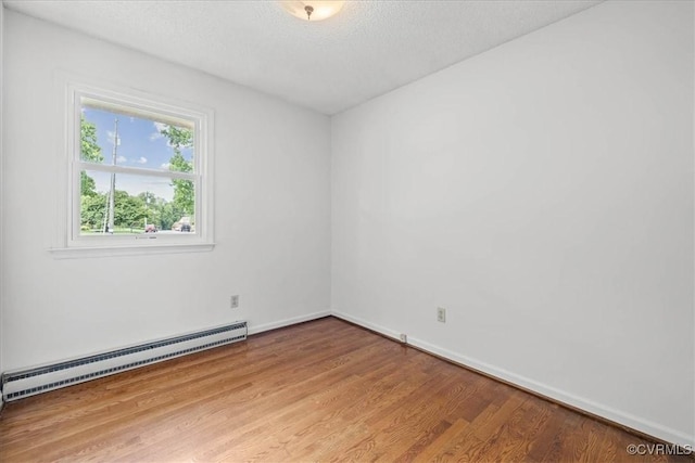 3304 N Marion Ave, Hopewell, VA 23860 - spare room featuring baseboard heating, light wood-type flooring, baseboards, and a textured ceiling